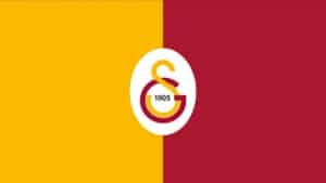 Sarı-kırmızı arka plan üzerinde Galatasaray amblemi ve 1905 yazılı arma.